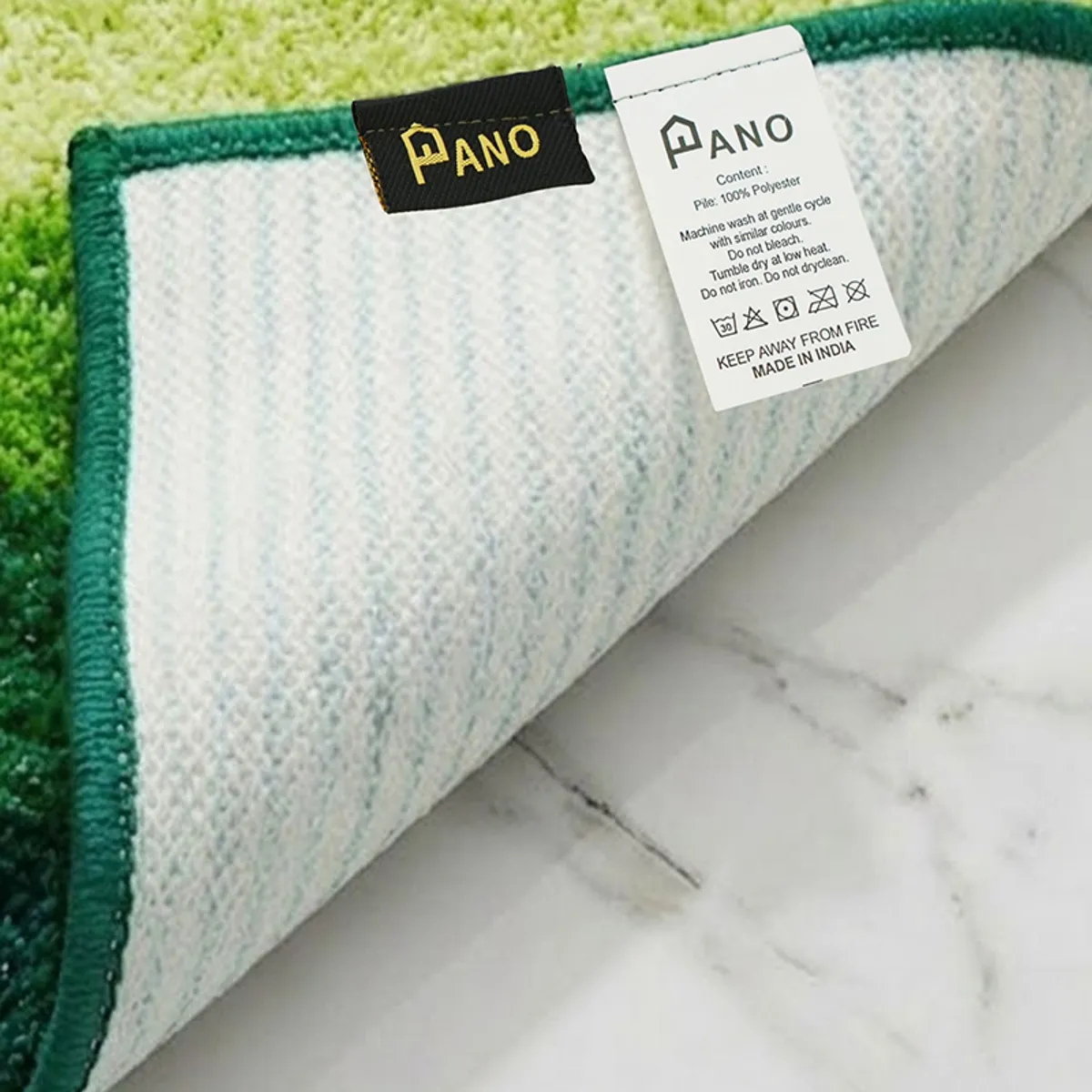 Underside of green rug showing its light anti-skid backing