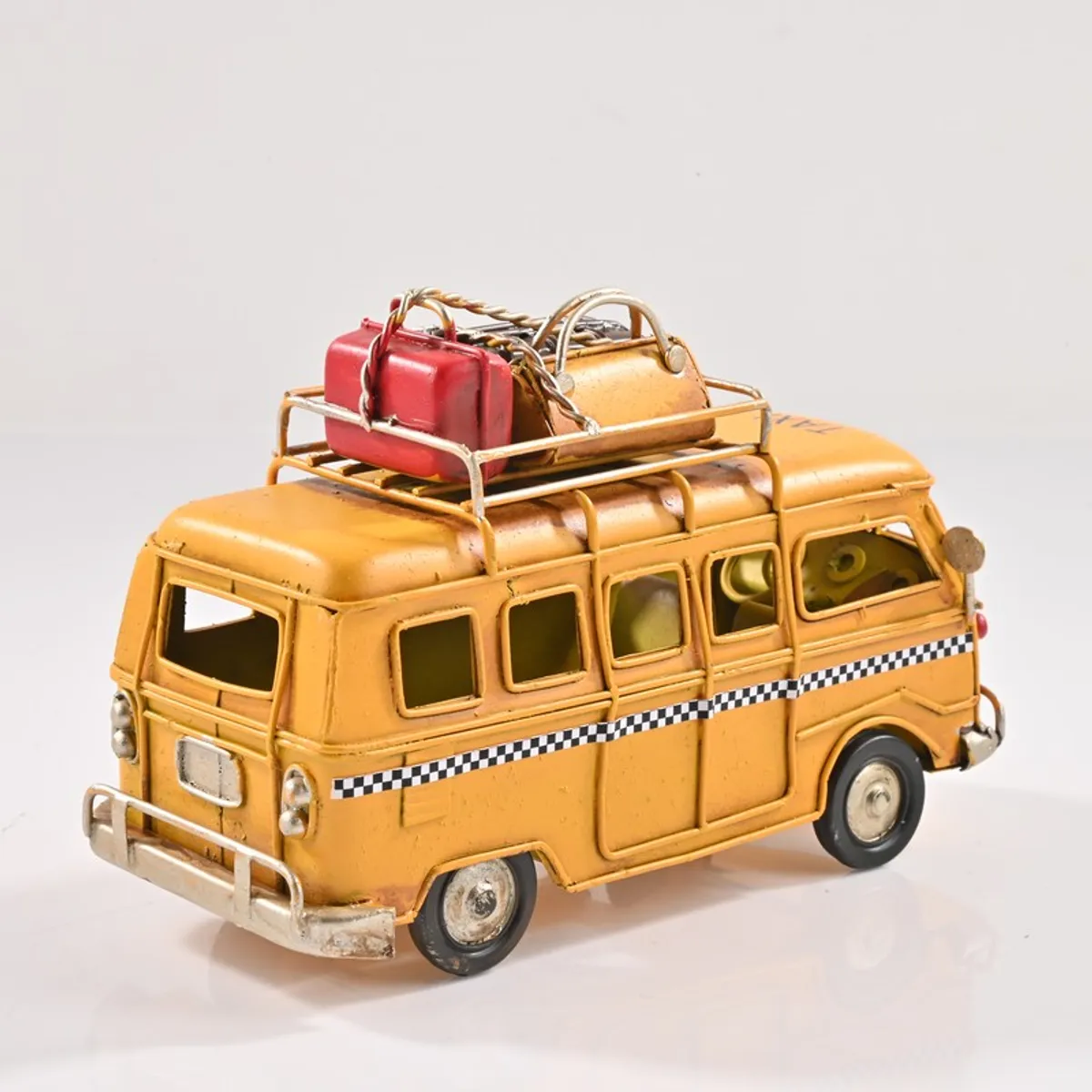 Rear angled view of yellow caravan showpiece on white background