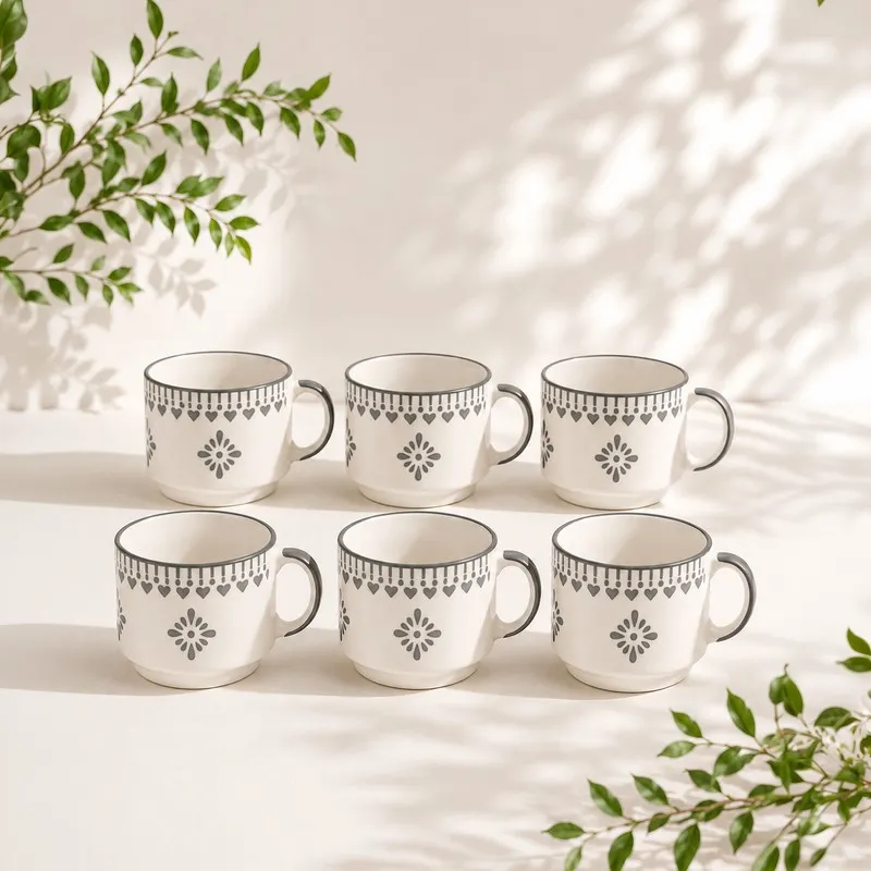 Set of six white tea cups with blue floral and heart border