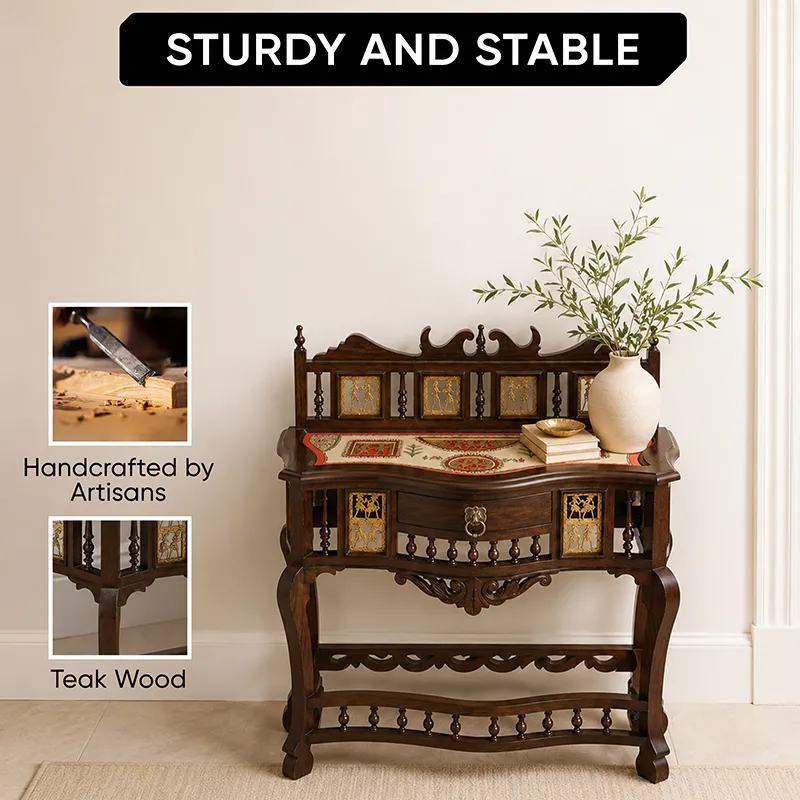 Styled brown console table with vase and books showing carved wooden details
