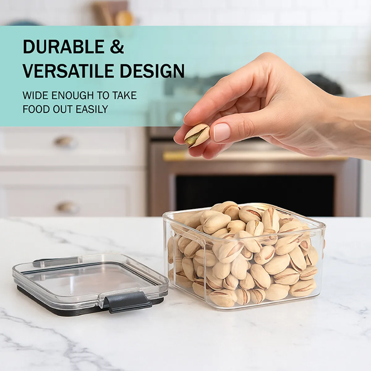 Open clear storage container with pistachios and black-rimmed lid on counter