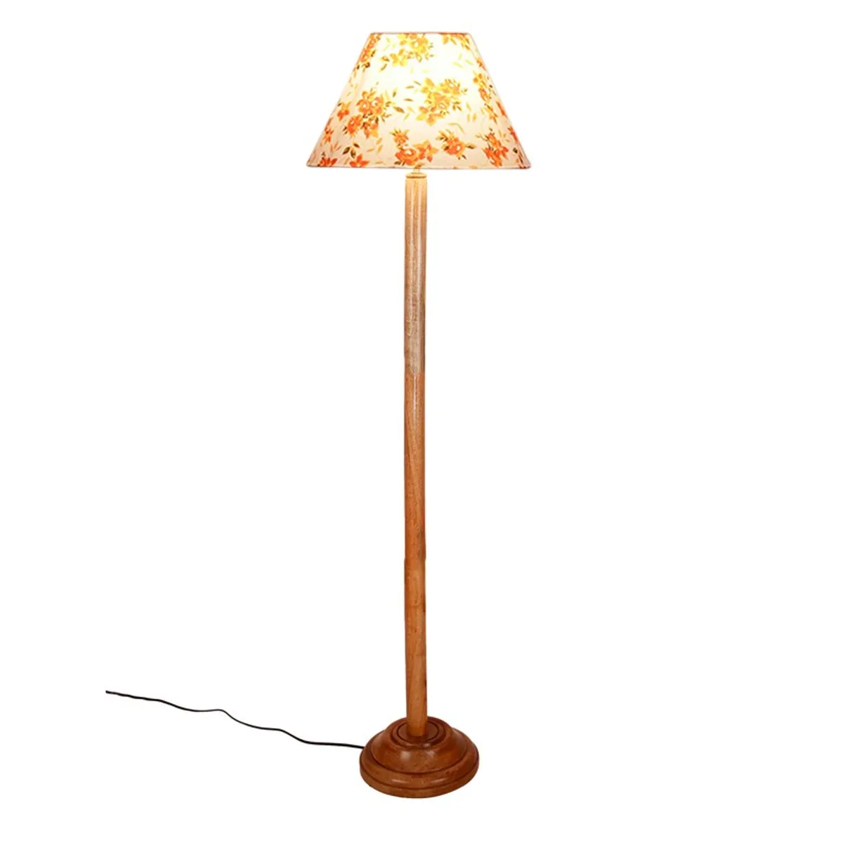 Wooden floor lamp with lit floral shade on a plain white background