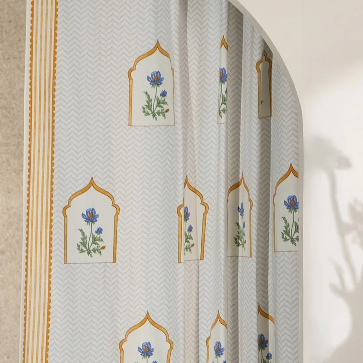 Close view of floral arch motifs and pale chevron curtain pattern