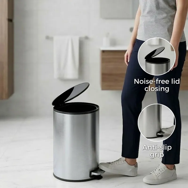 Silver pedal dustbin with open lid in a bathroom setting