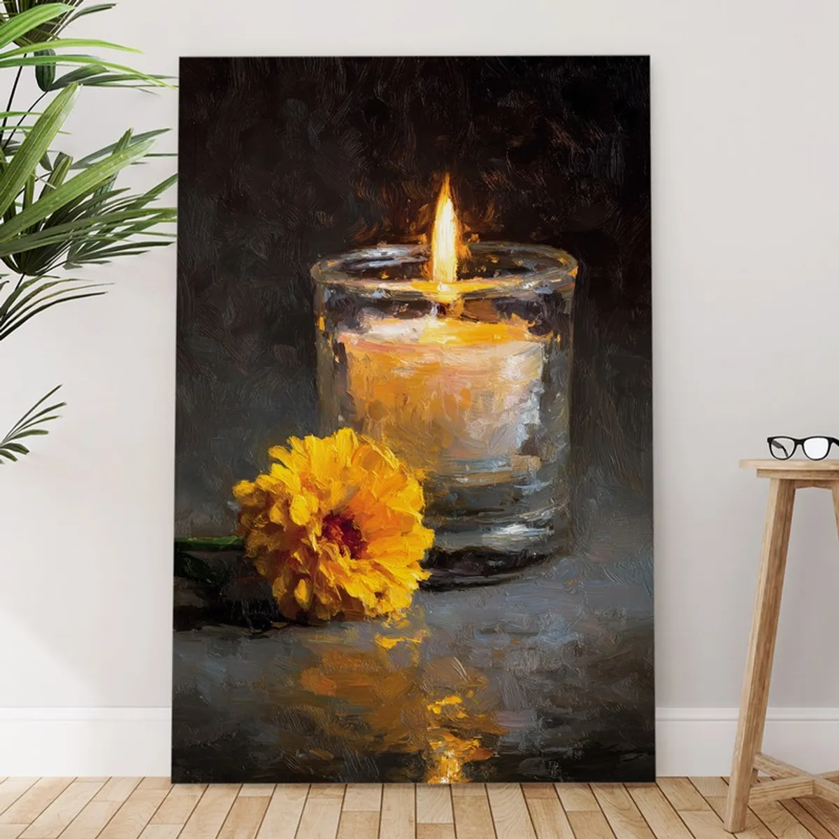 Large rectangular wall painting with glowing candle and yellow flower leaning against a wall