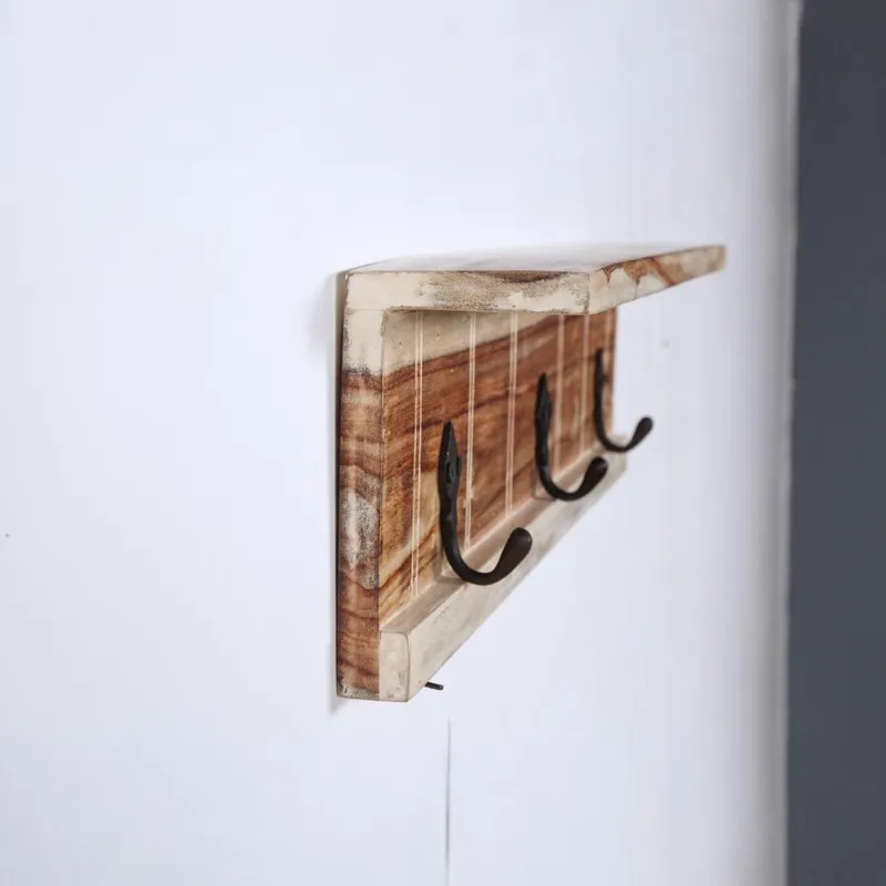 Side view of the wooden key holder showing the projecting top ledge and hooks