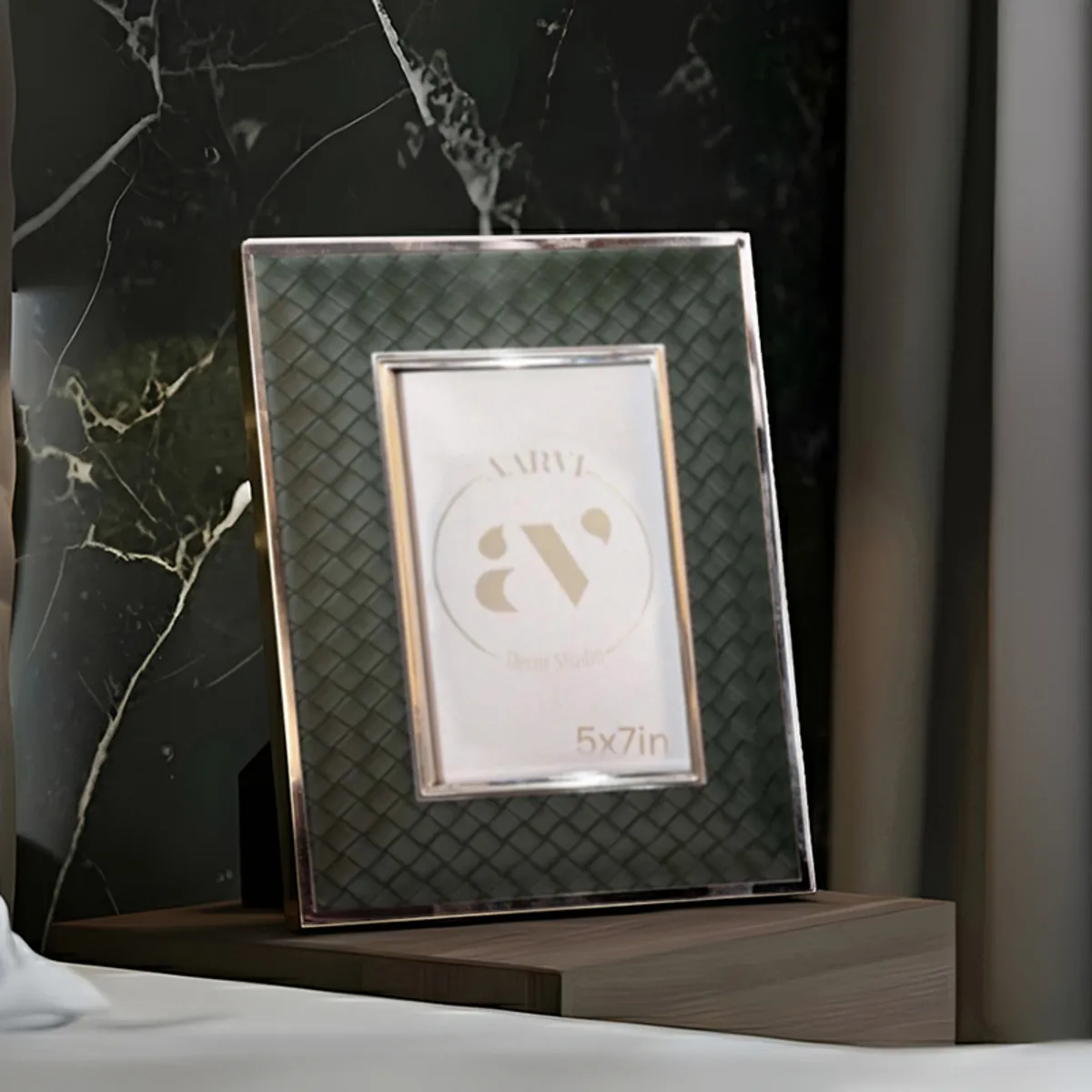 Green rectangular photo frame with silver border on a bedside table
