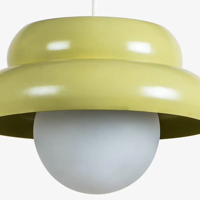 Close-up of pistachio green ceiling lamp and white glass globe shade