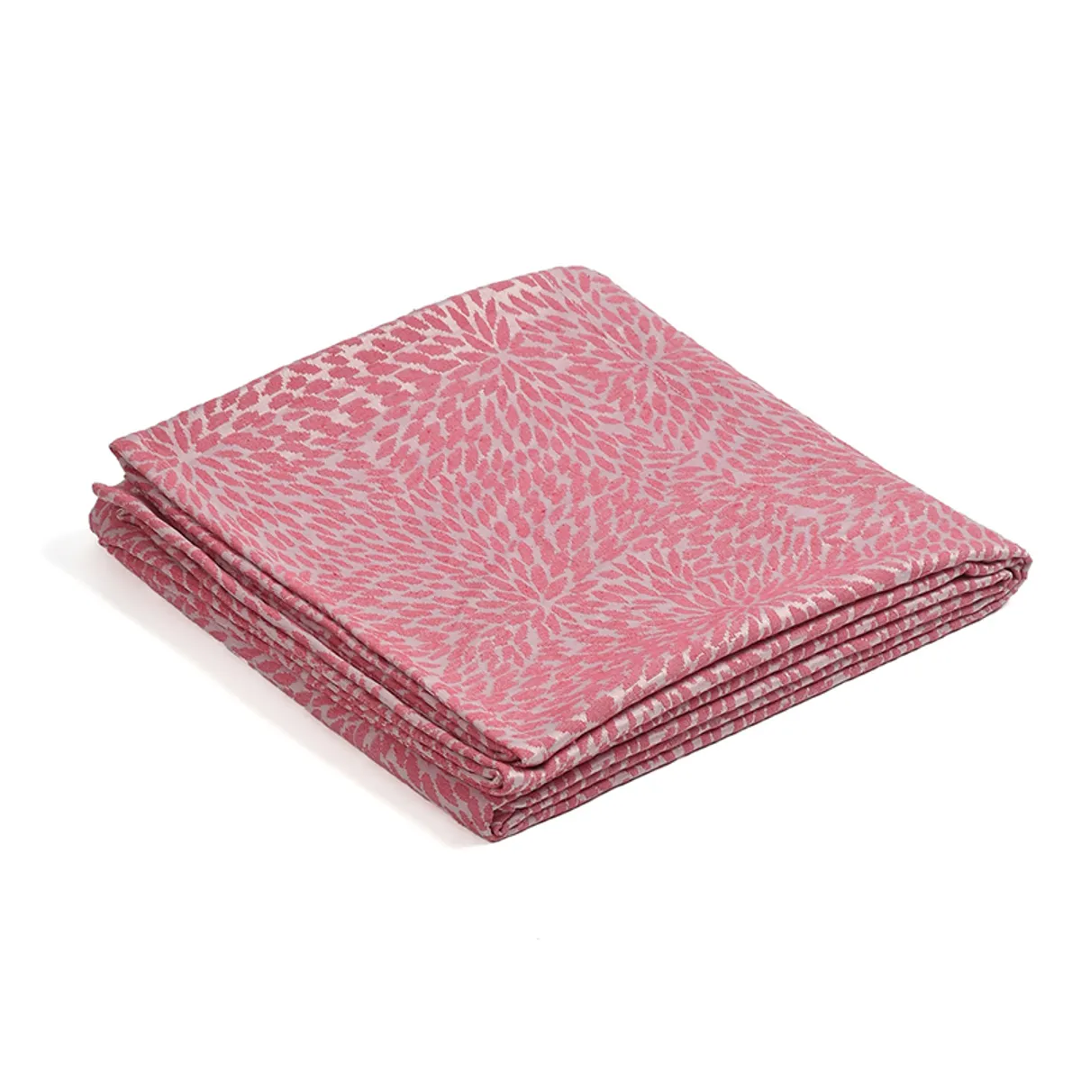 Folded pink patterned cotton throw on a white background
