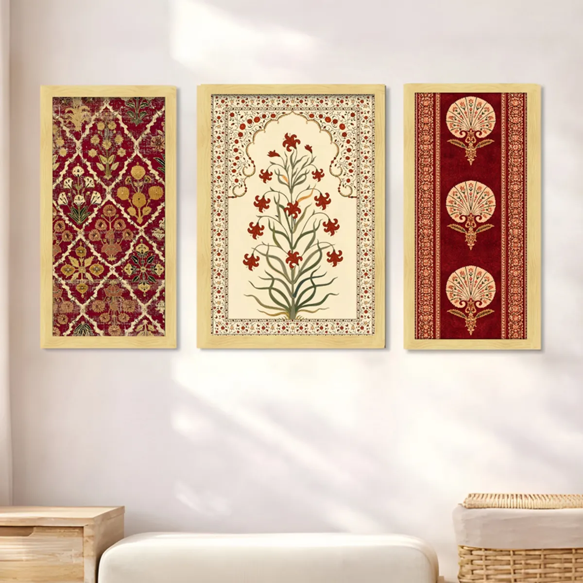 Three rectangular framed wall art panels with Mughal-inspired floral motifs on a light wall