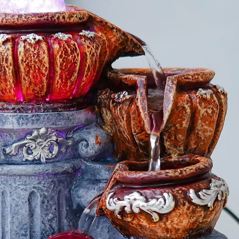 Close-up of water flowing between two brown pots on the fountain
