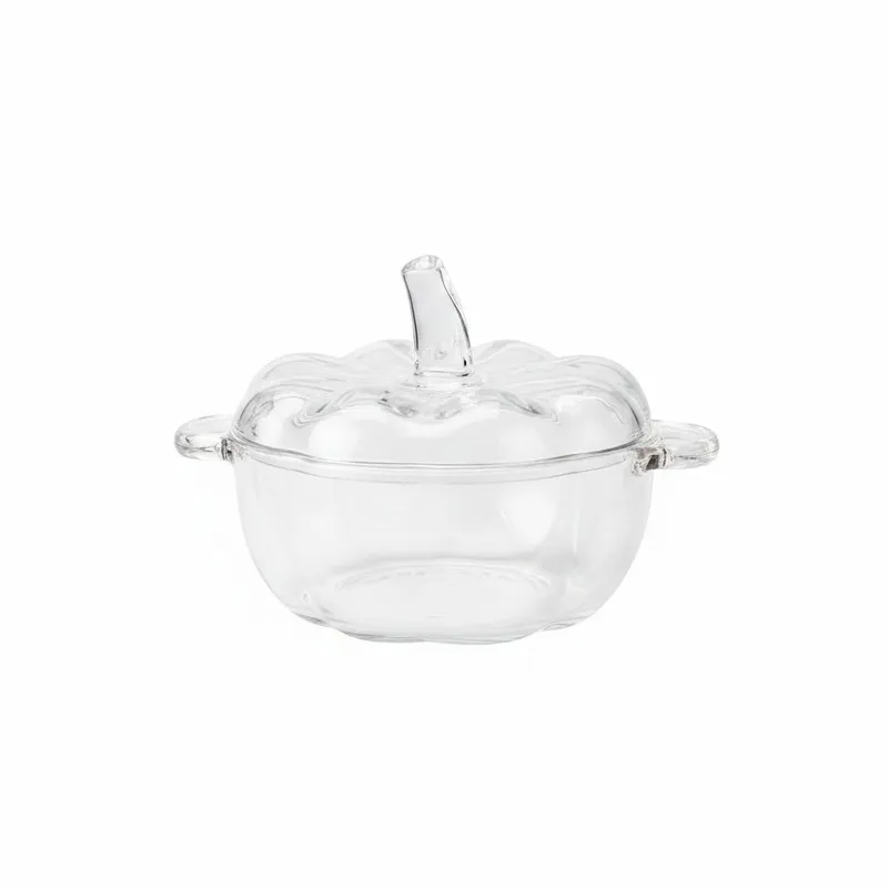 Empty transparent glass snack bowl with sculpted lid on a white background
