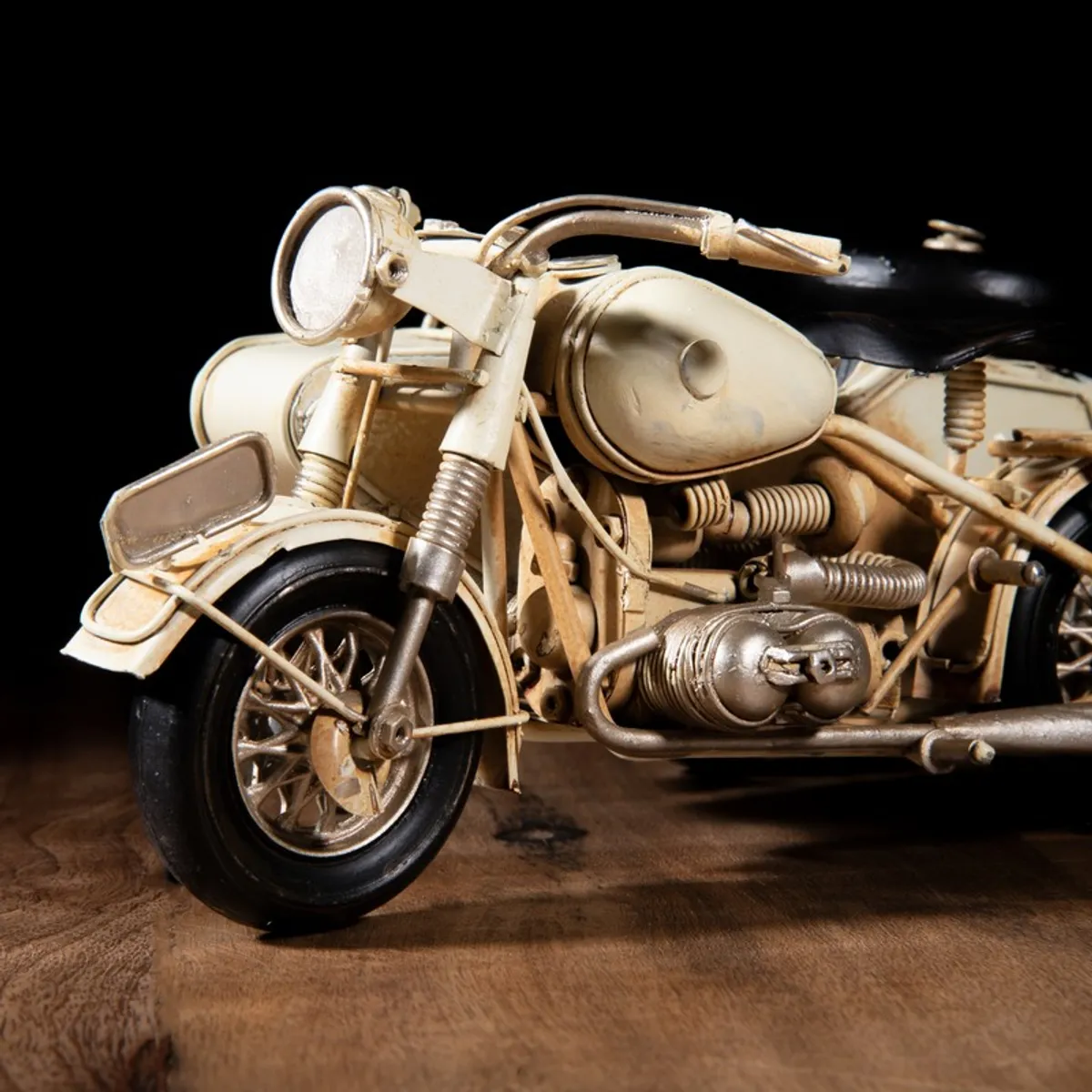 Close-up of front wheel and engine detail on motorcycle showpiece