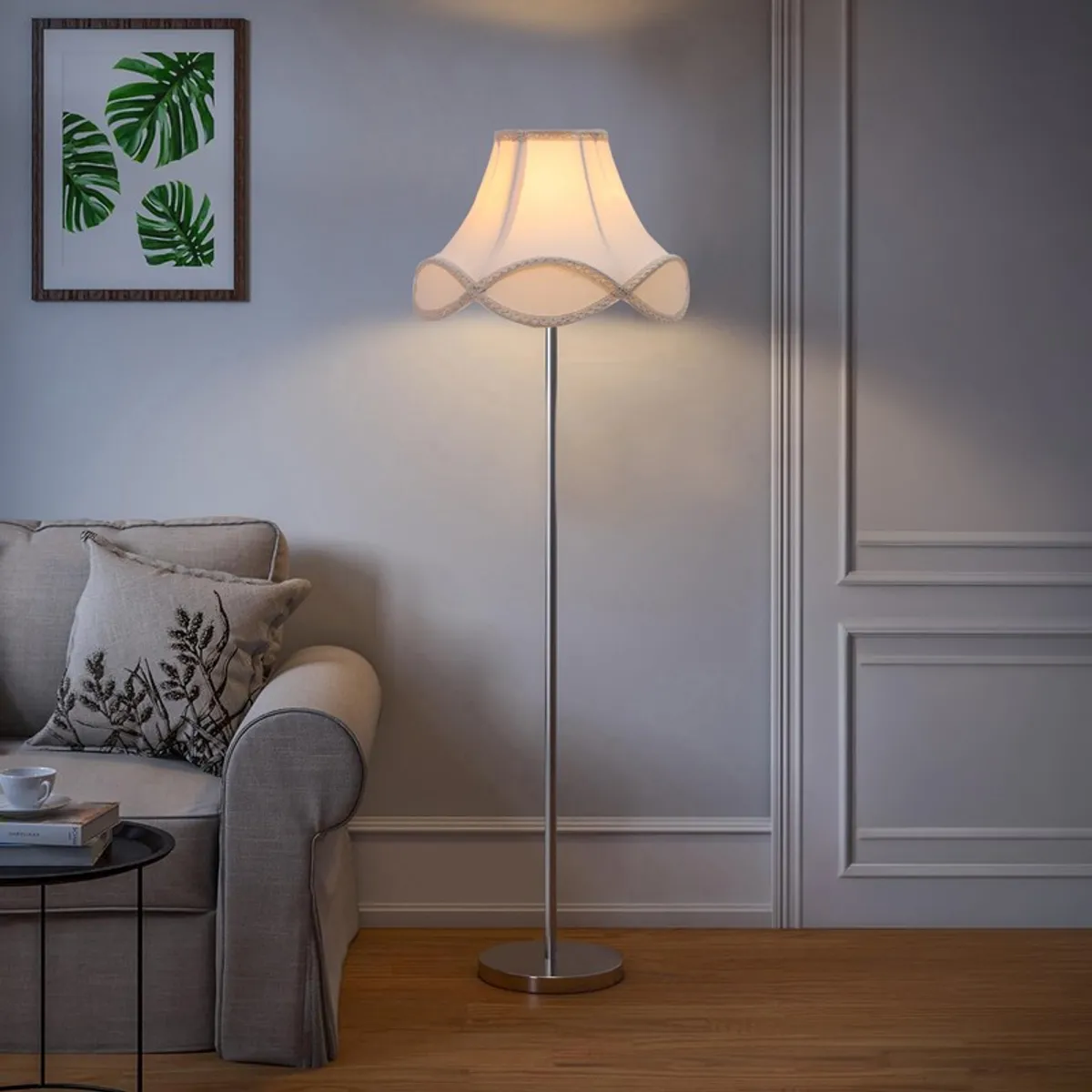 Ivory cotton floor lamp illuminating a grey sofa in a classic room