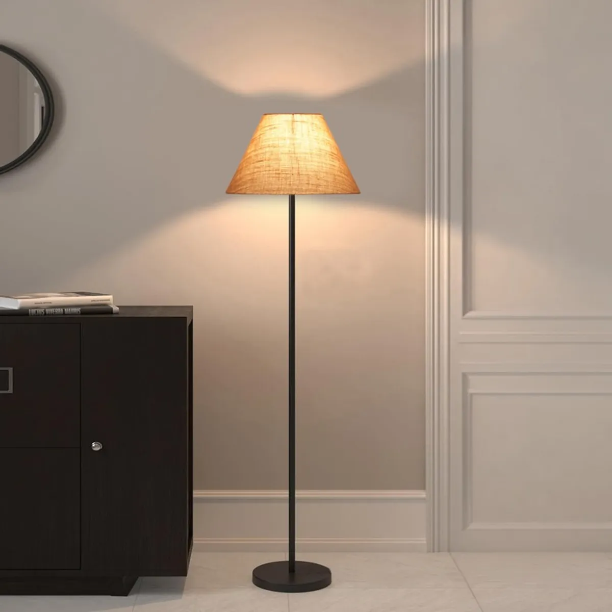 Lit tapered floor lamp with beige shade and black stand against a neutral wall