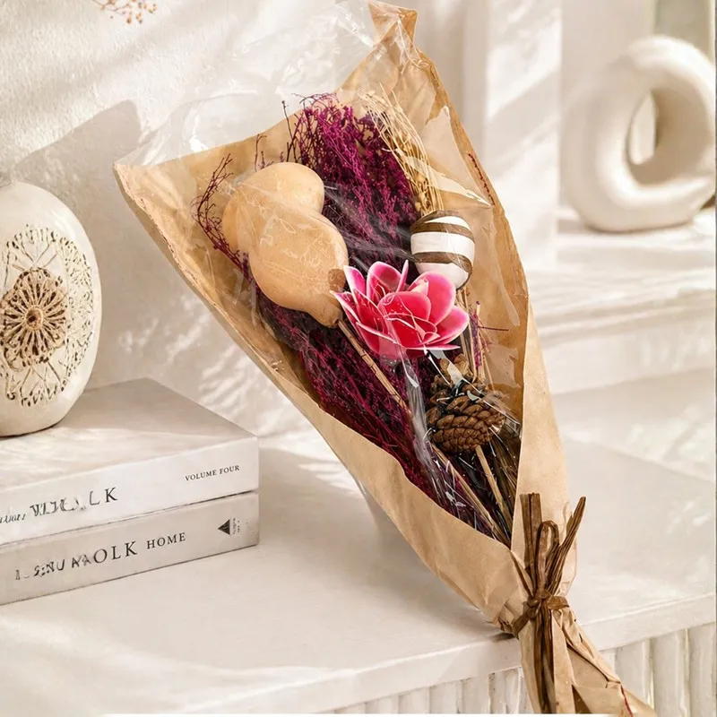 Wrapped pink dried flower bouquet with decorative natural elements