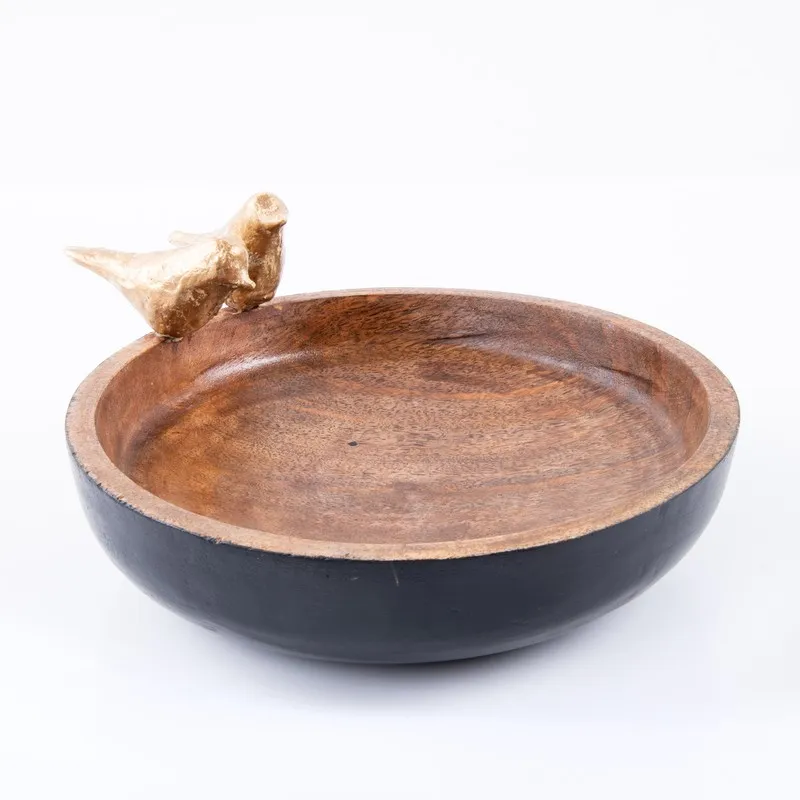 Close view of the bowl showing its brown wood interior and black exterior