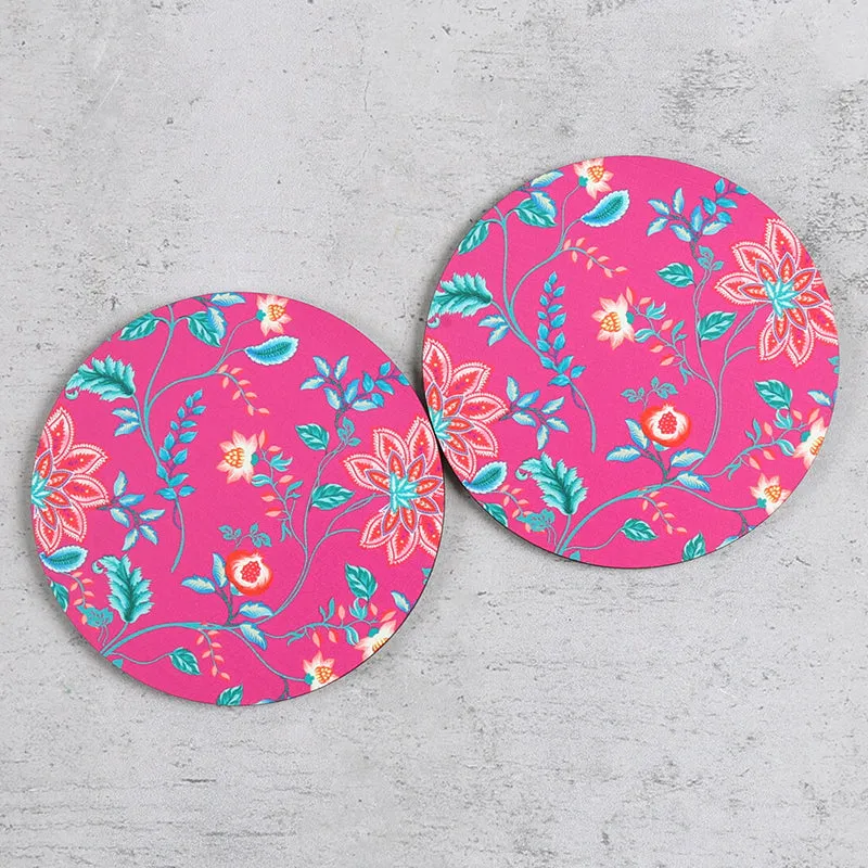 Two round pink floral coasters viewed from above