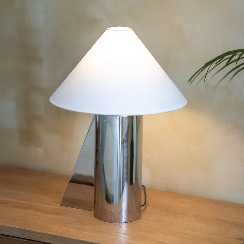 Close view of silver table lamp with white cotton shade