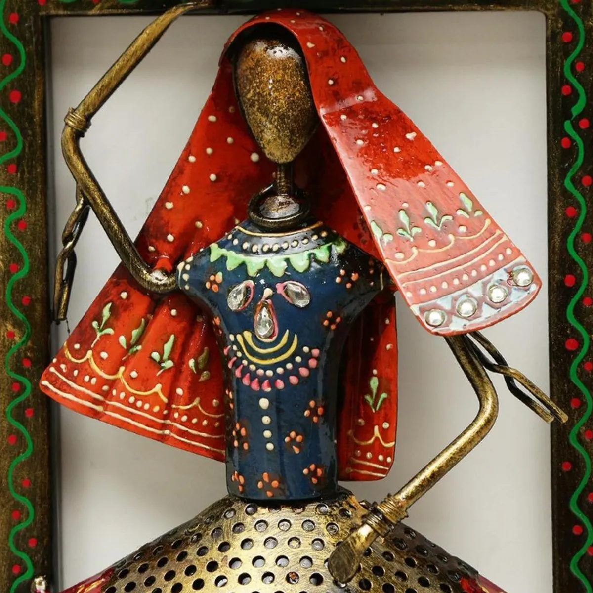 Close-up of hand-painted figure detail on the metal wall accent