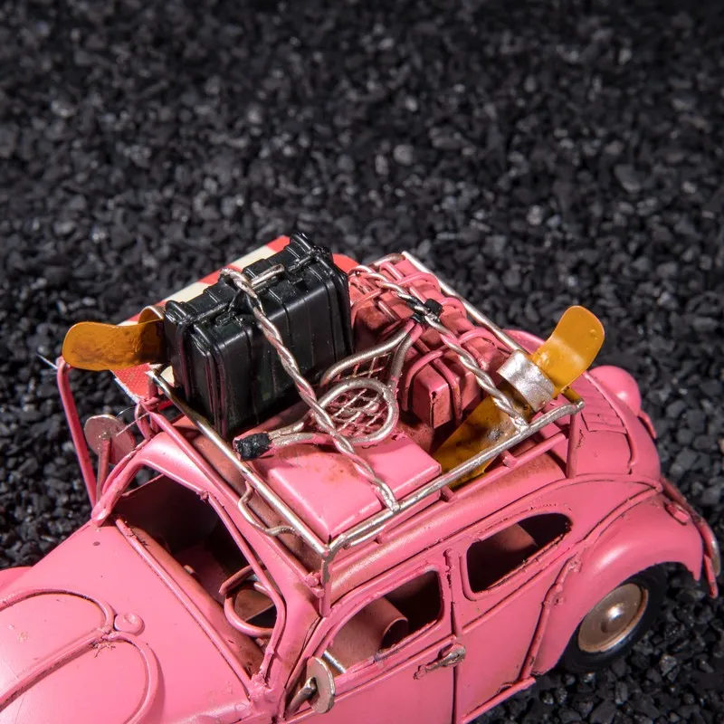Top view of pink beetle car showpiece with luggage and travel details