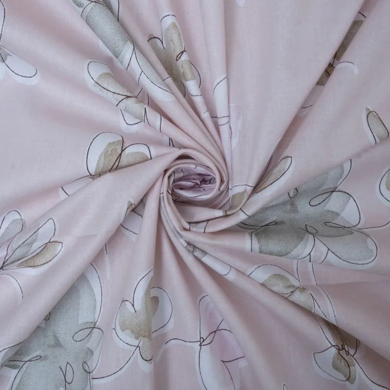 Pink printed cotton fabric gathered to show drape and surface texture