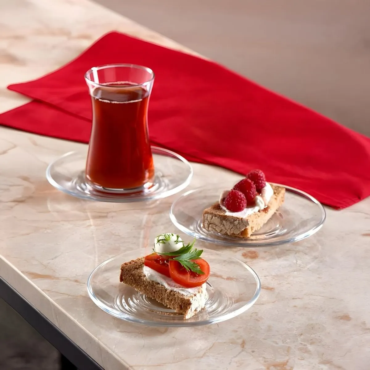 Transparent glass saucers used for tea and bite-sized snacks