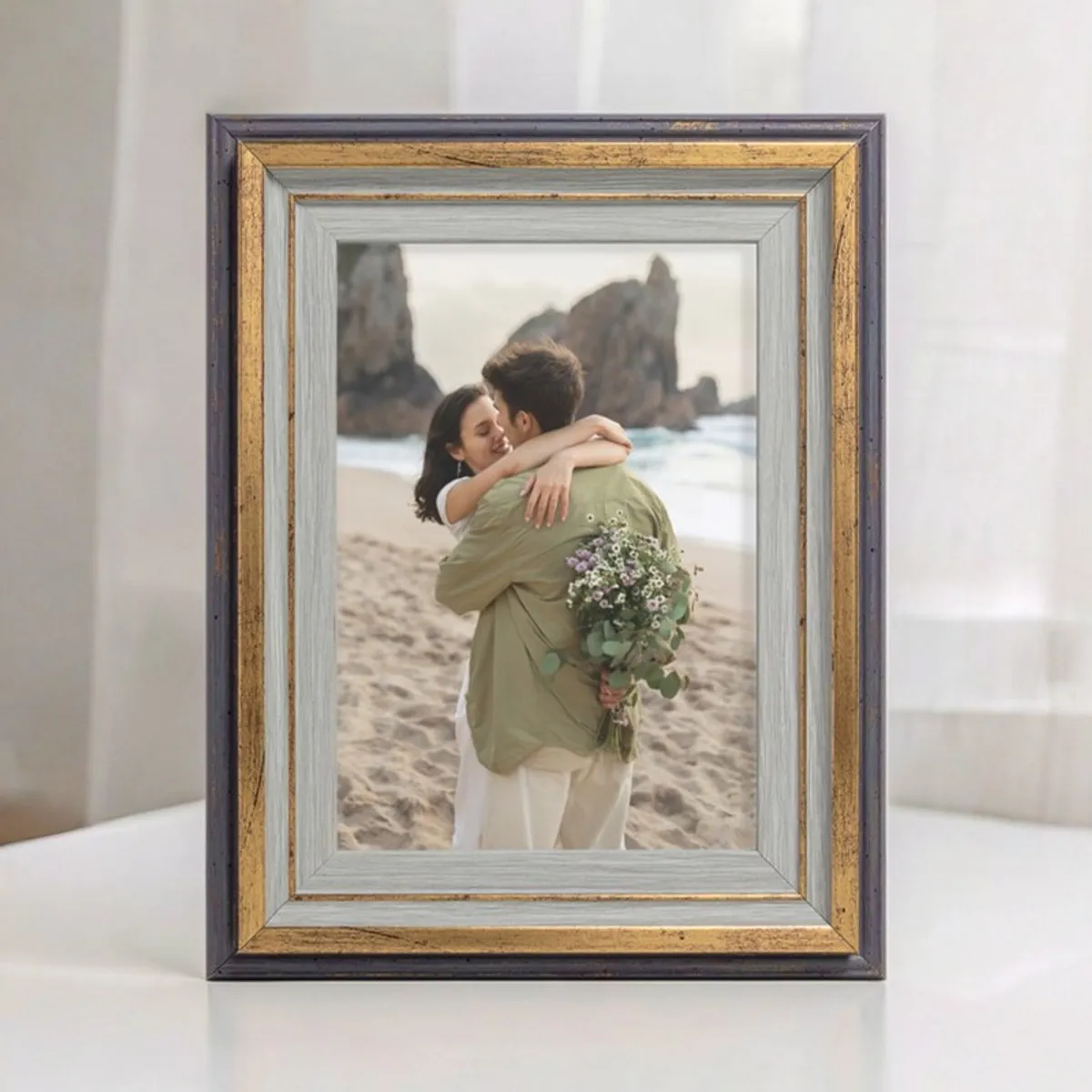 Front view of the photo frame with layered gold and grey border