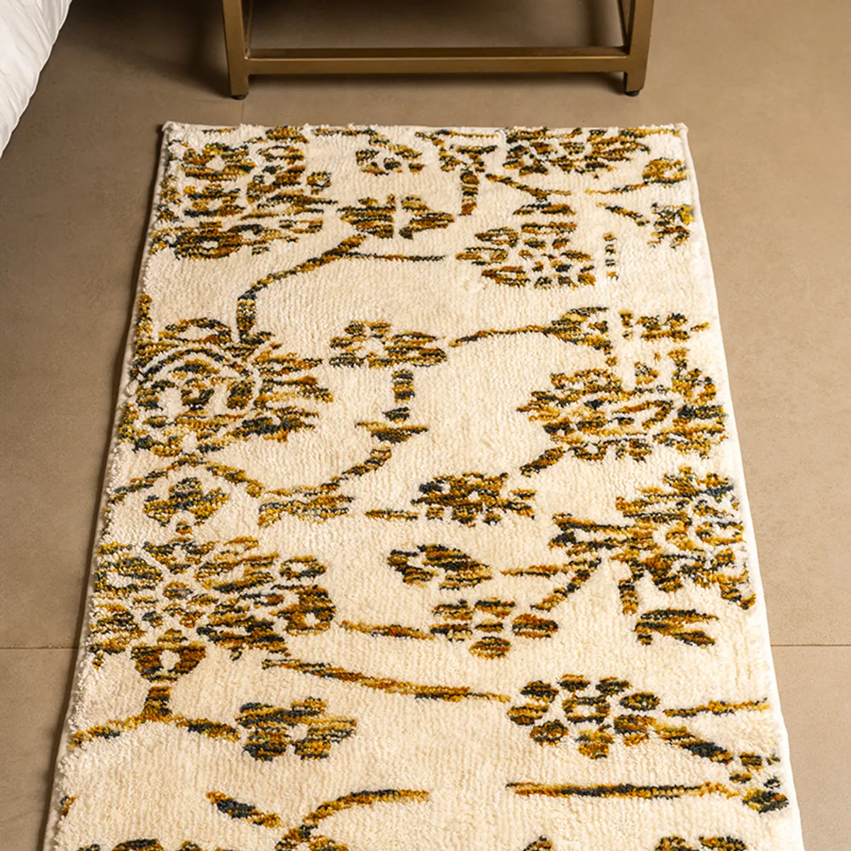 Close view of the ivory runner's golden-brown floral pattern