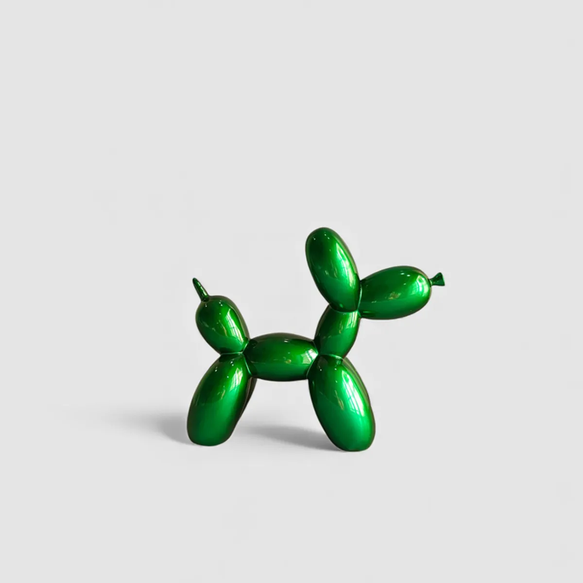Glossy green balloon-dog showpiece shown against a plain light background.