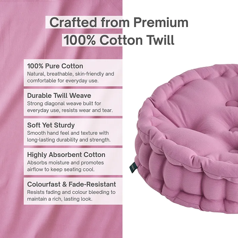 Close-up of a lilac-purple cotton cushion with a softly textured surface.