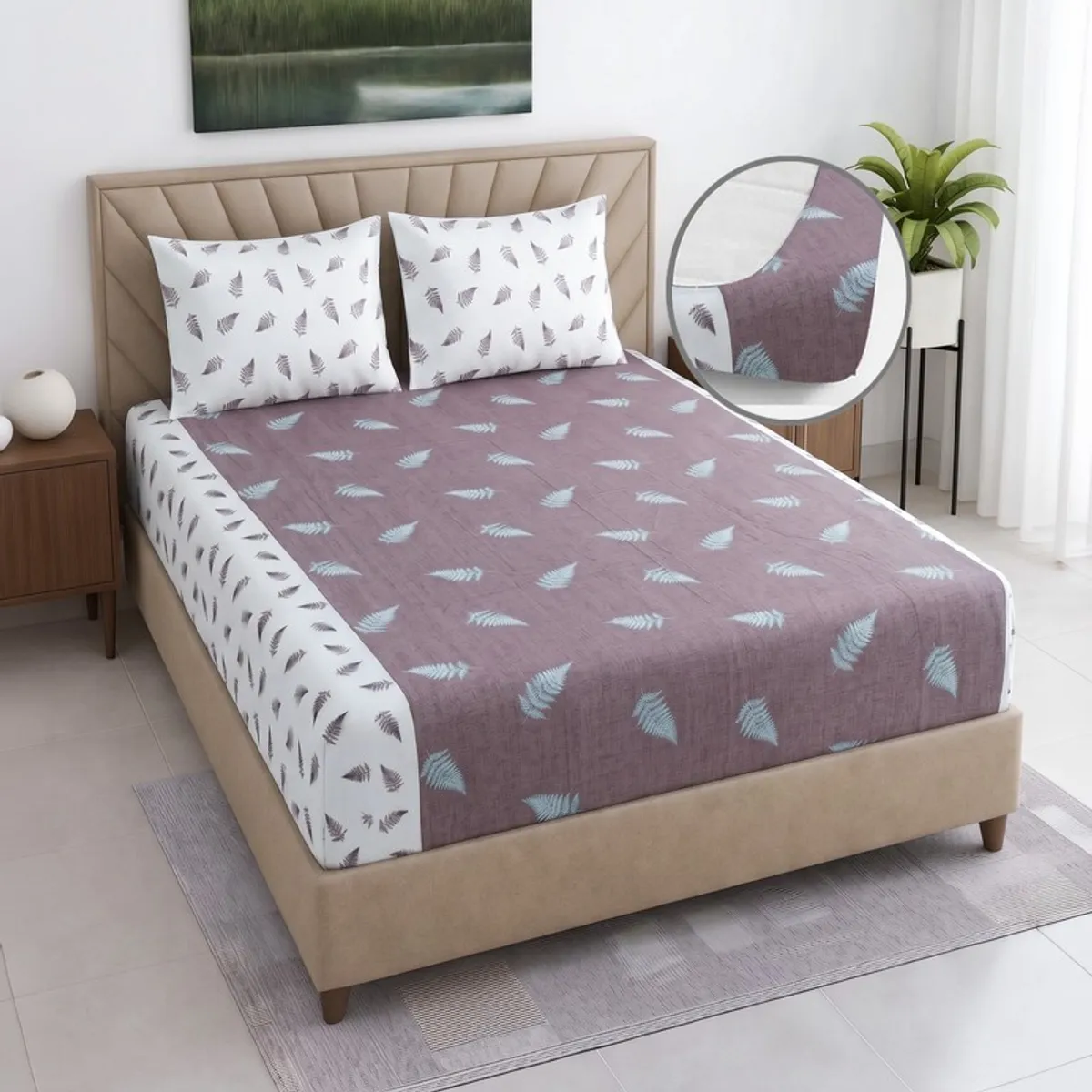 Purple and white floral fitted bedsheet styled on a modern bed with two pillow covers