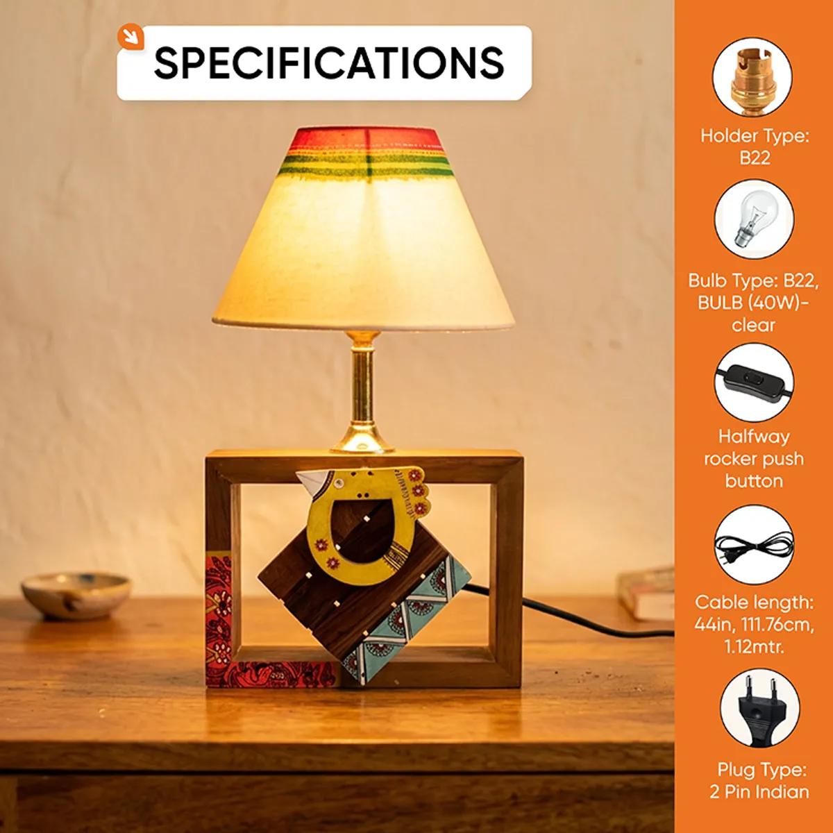 Front view of lit wooden table lamp with striped shade and cord