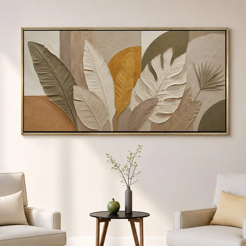 Contemporary leaf wall art in muted earthy tones displayed above accent chairs