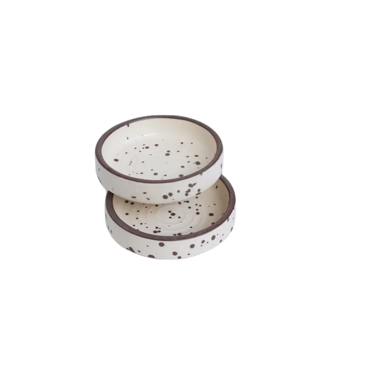 Two stacked speckled white dip bowls on a white background