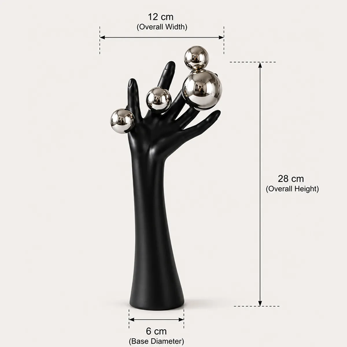 Black hand-shaped decorative showpiece with silver spheres on a plain background