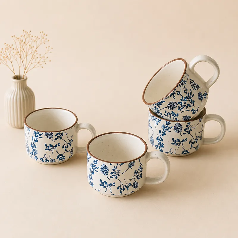 Blue and white floral ceramic cups shown with a teapot