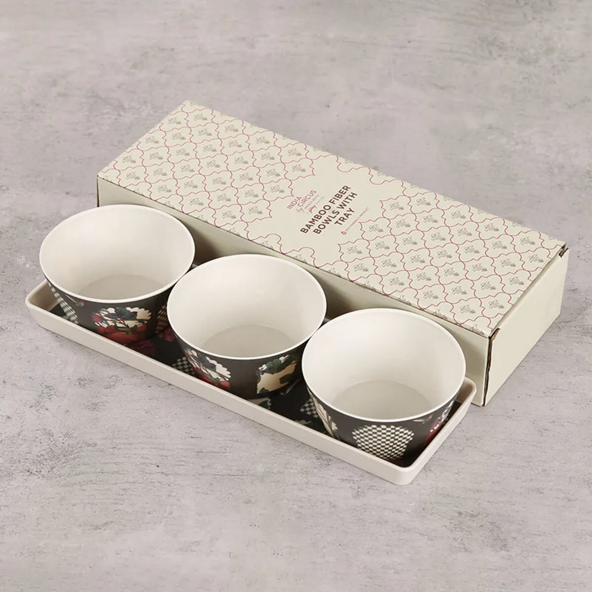 Three patterned snack bowls and tray placed beside their gift box