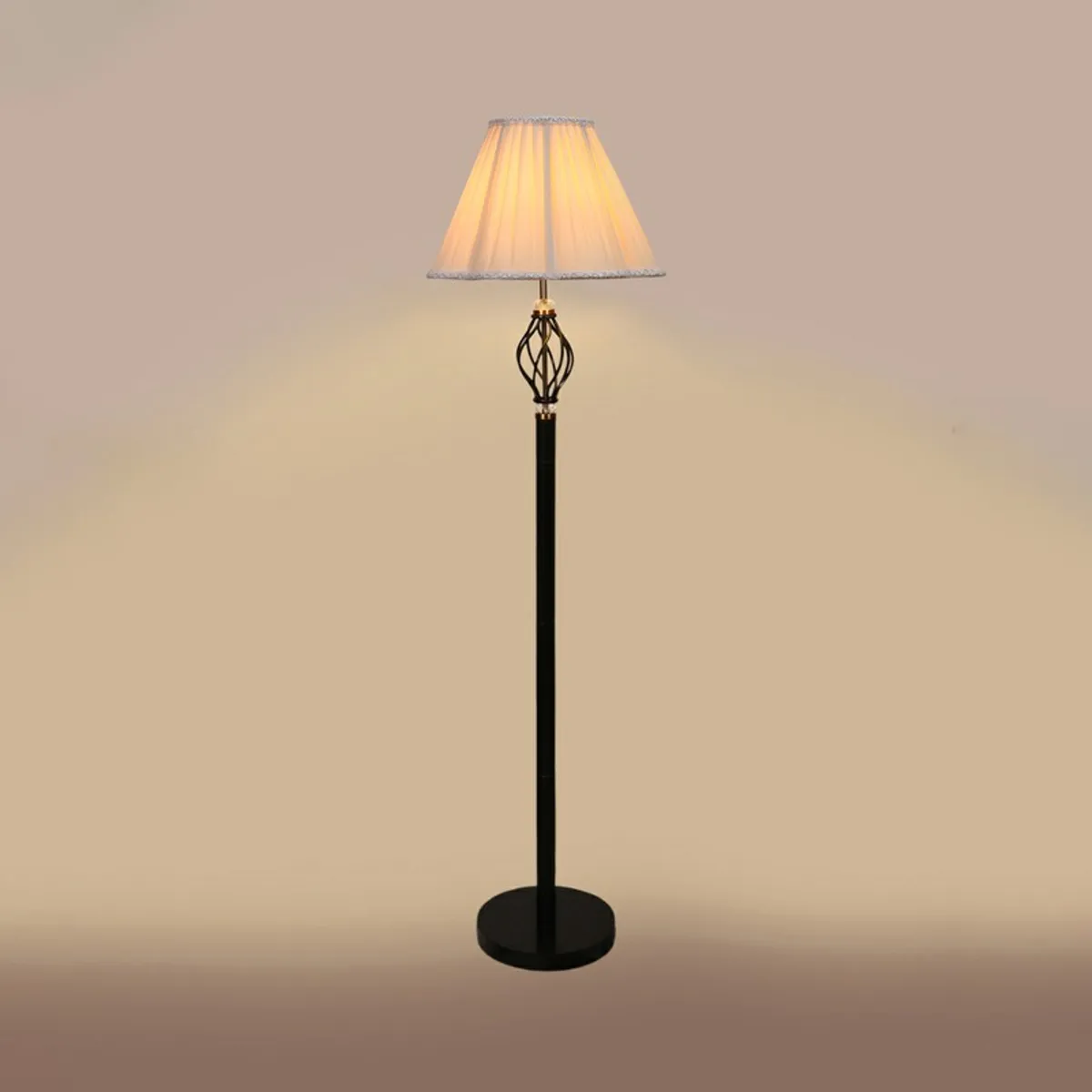 Ivory pleated floor lamp lit against a beige background