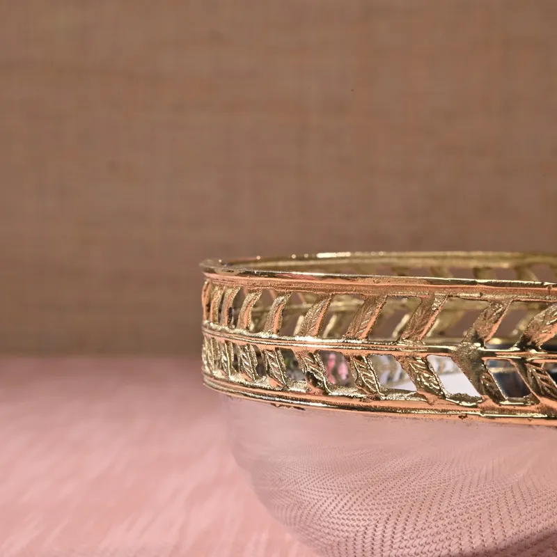 Close-up of the bowl's ornate gold openwork rim and glossy silver body