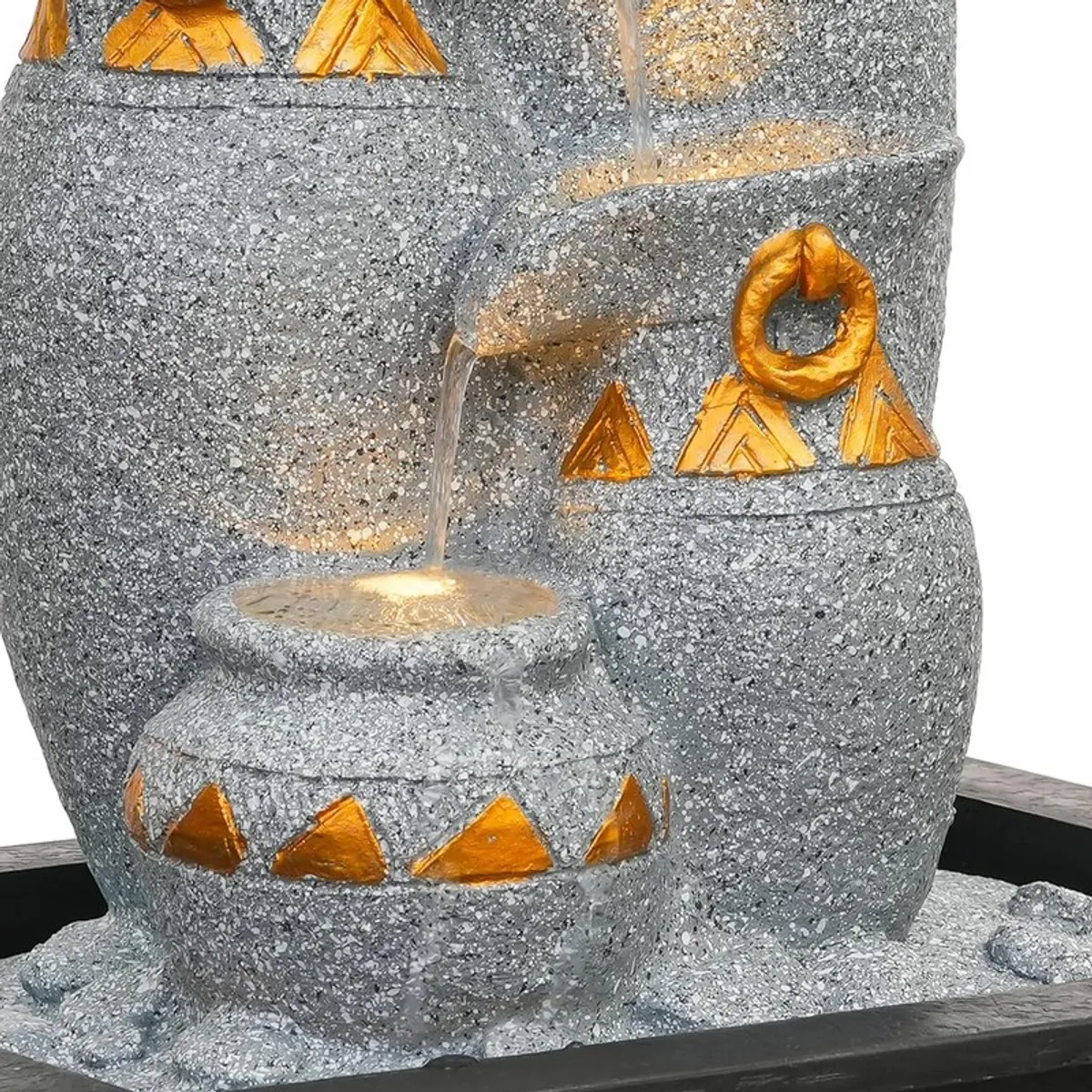 Close-up of the cascading water flow and gold geometric detailing.