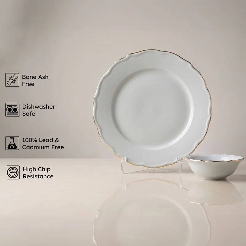 Single white plate and bowl with gold rim on display stands