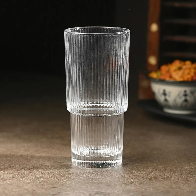 Empty tall clear ribbed glass on a tabletop