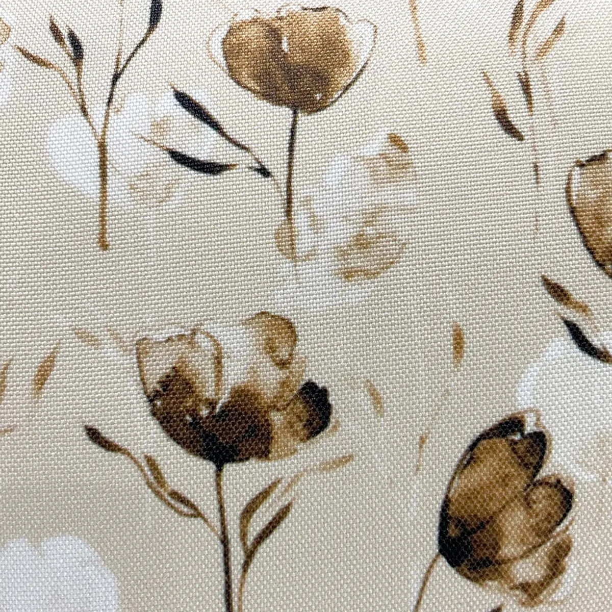 Close-up of a floral printed cushion cover with a woven texture