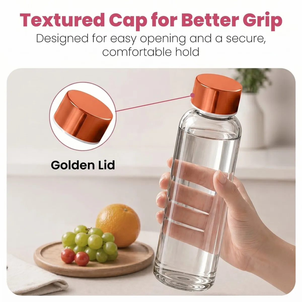 Hand holding a clear glass bottle with a gold-toned lid