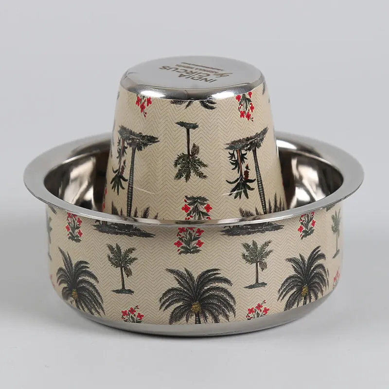 Close-up of a Tumbler nested inside an ivory Katori with palm tree motifs.