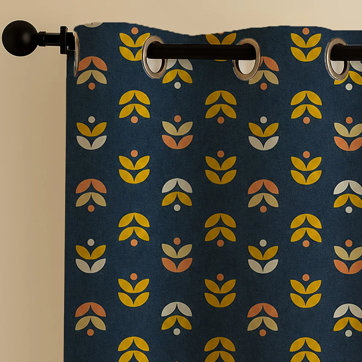 Close-up of blue curtain with yellow and peach motifs and eyelets