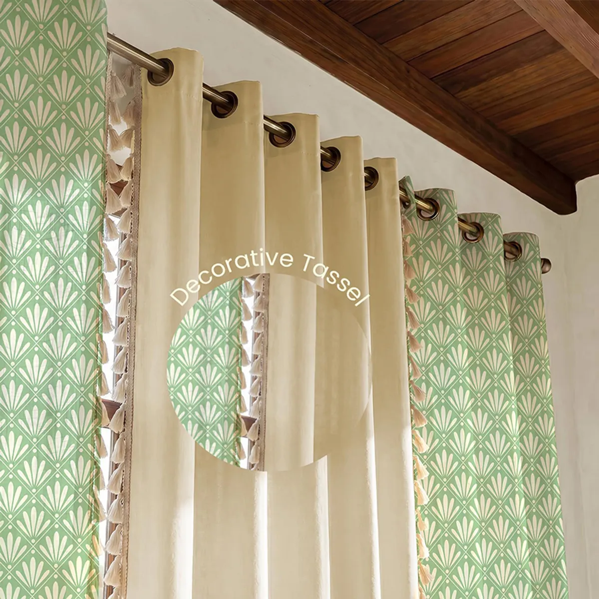 Off-white and sage curtains shown with decorative tasselled trim