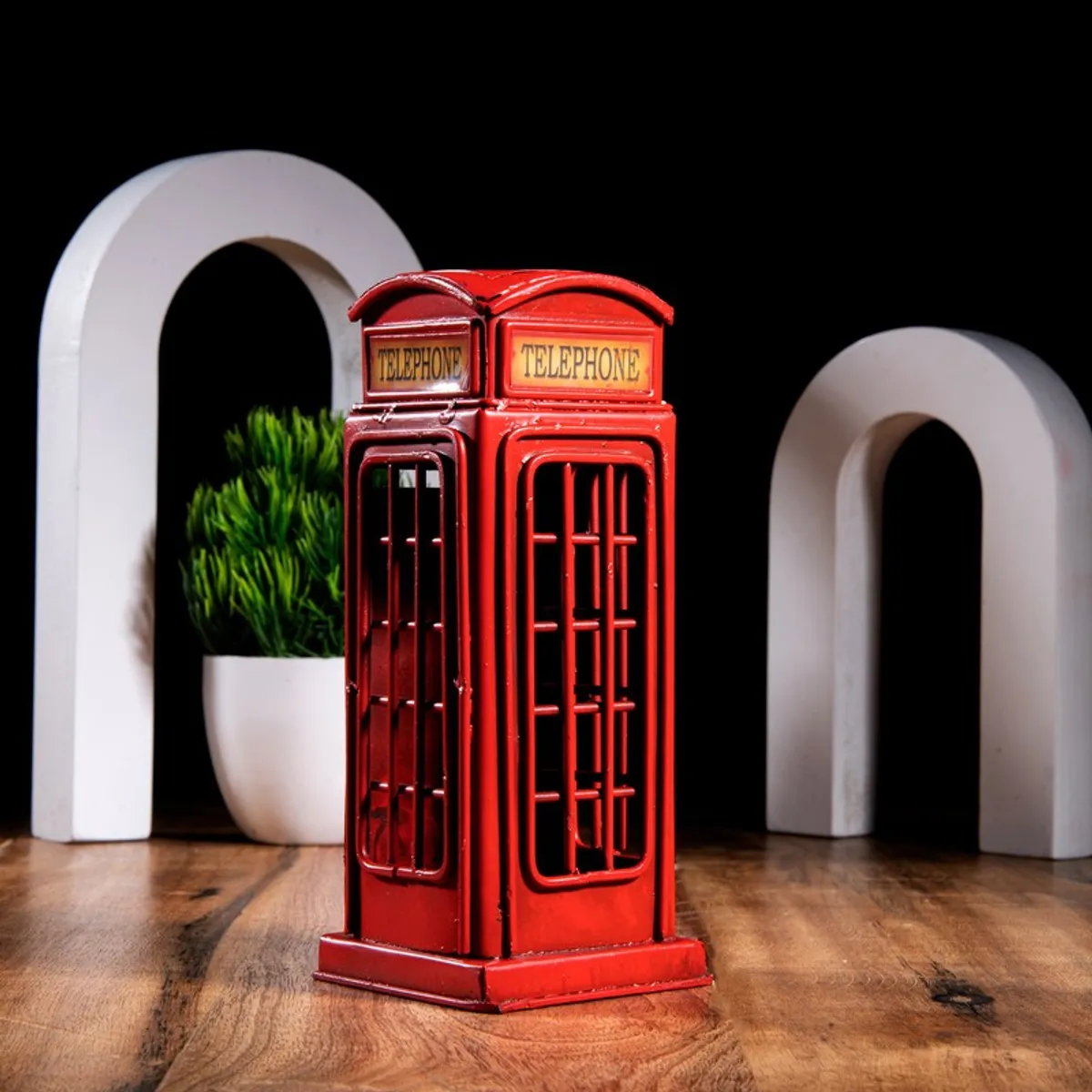 Red telephone booth showpiece with open grille-style sides