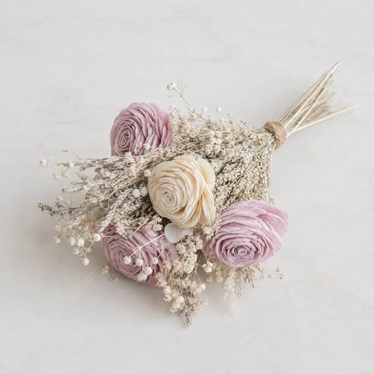 Top view of a bundled lilac and off-white flower bunch with delicate filler stems